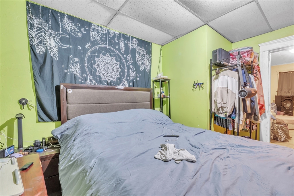 215 Beacon Street Worcester, MA 01610 - Photo 9 of 24 a bedroom with a bed and a mirror