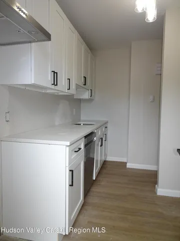 a kitchen with stainless steel appliances a sink and a stove