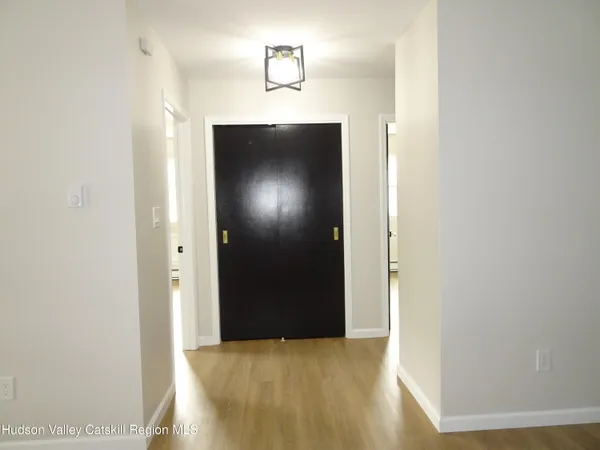 a view of hallway with wooden floor