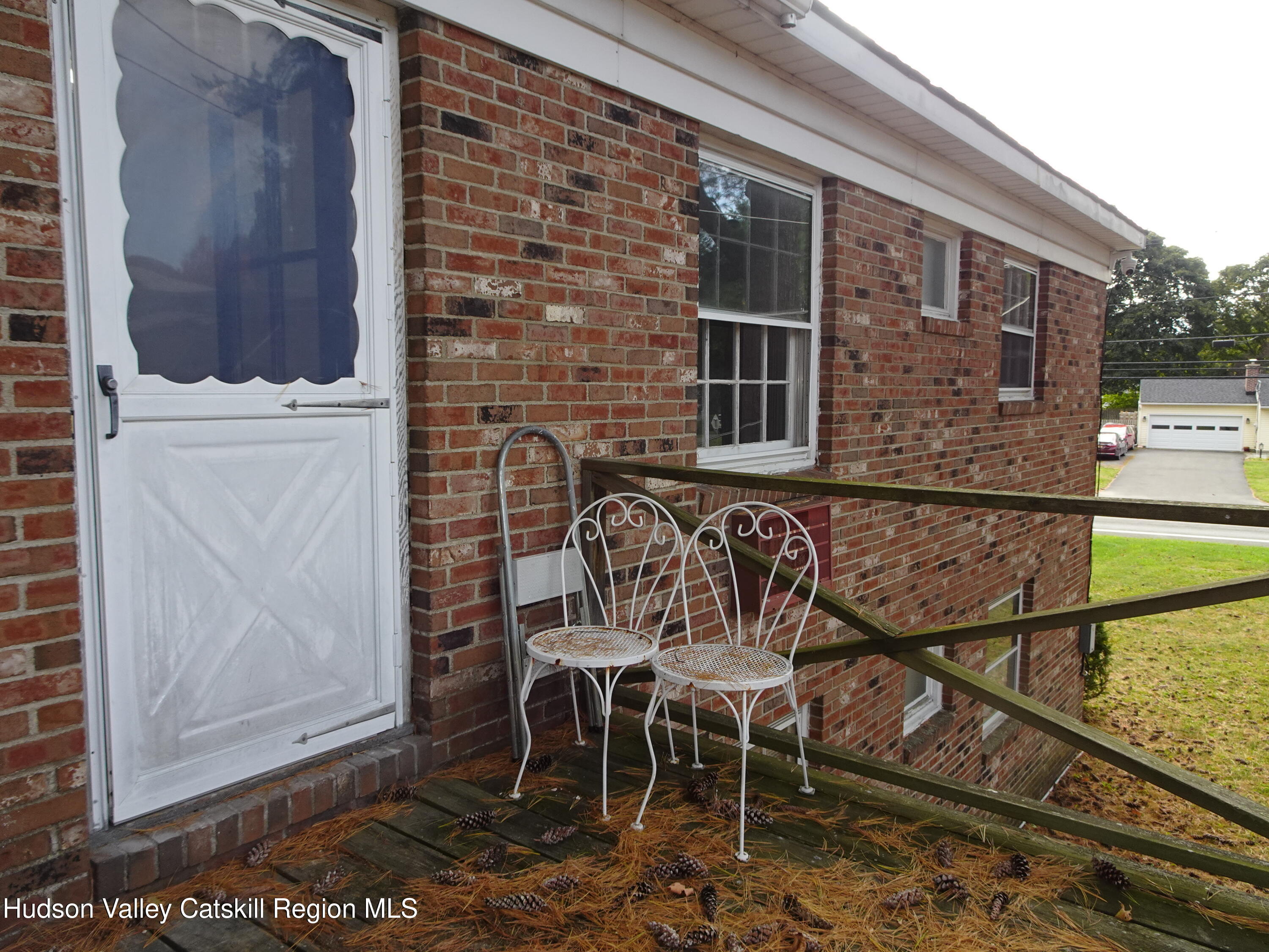 167 Highway 23, Unit 1C Claverack-Red Mills, NY 12513 - Photo 17 of 18 a view of a balcony with chairs and a potted plant