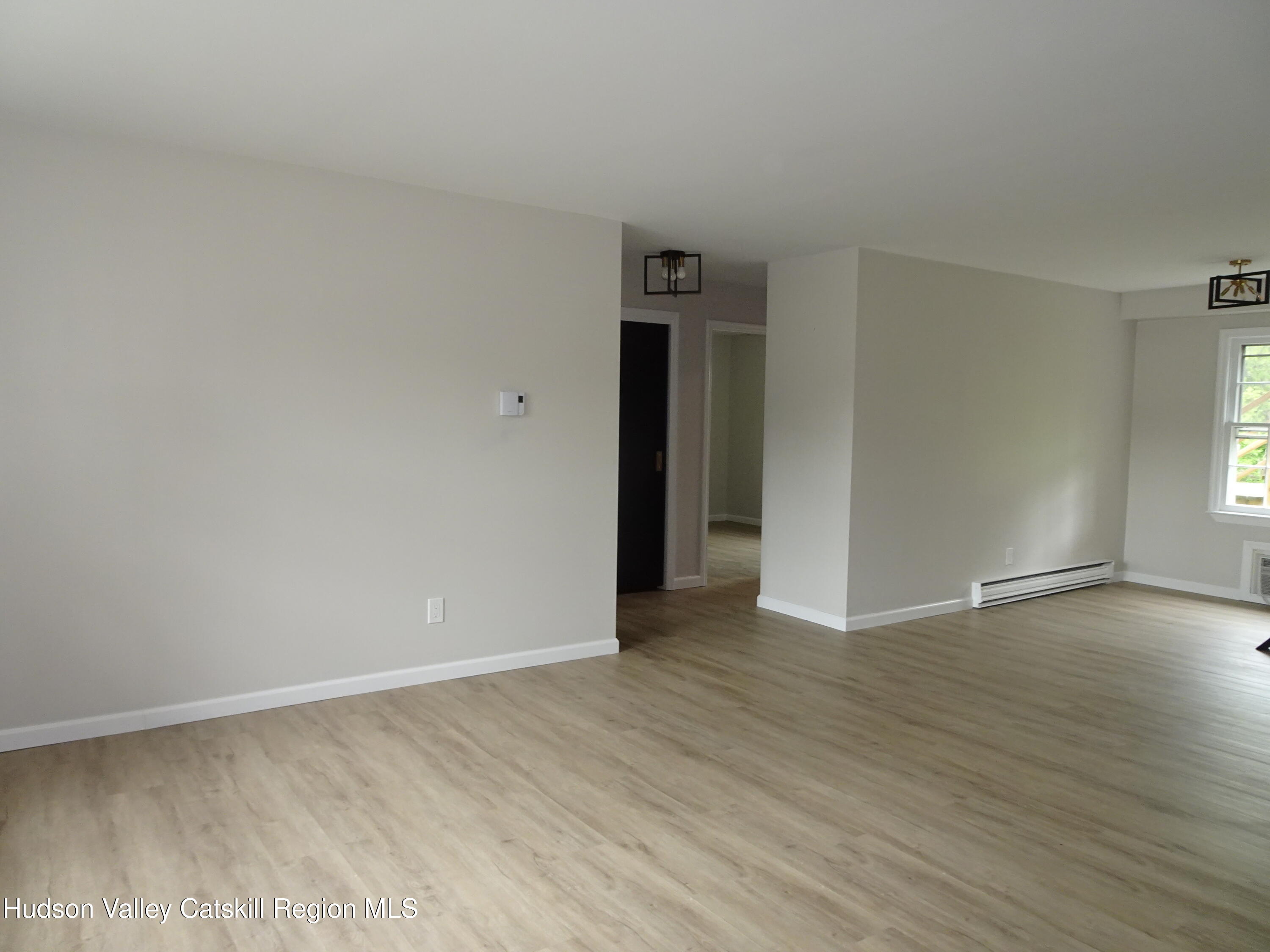 167 Highway 23, Unit 1C Claverack-Red Mills, NY 12513 - Photo 8 of 18 a view of an empty room with wooden floor