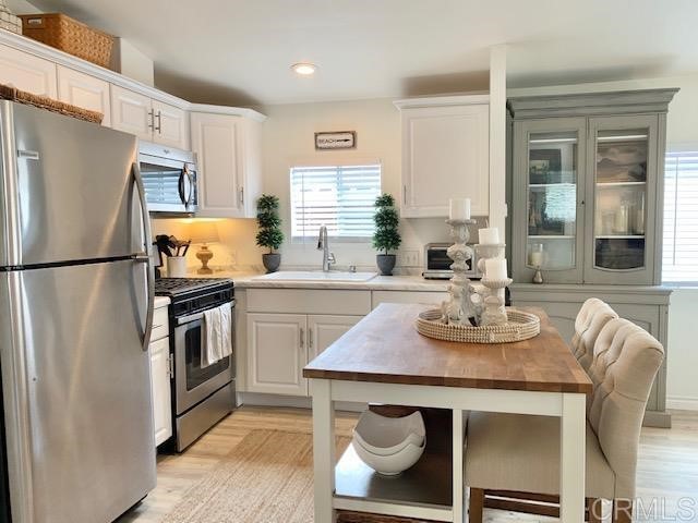 123 Jasper Street, Unit 23 Encinitas, CA 92024 - Photo 13 of 23 a kitchen with stainless steel appliances granite countertop a sink stove refrigerator and cabinets