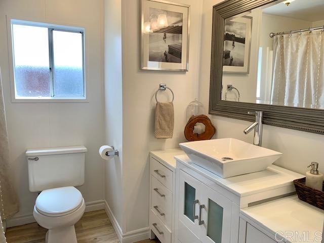 123 Jasper Street, Unit 23 Encinitas, CA 92024 - Photo 15 of 23 a bathroom with a toilet sink and mirror