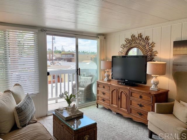 123 Jasper Street, Unit 23 Encinitas, CA 92024 - Photo 18 of 23 a living room with furniture and a flat screen tv