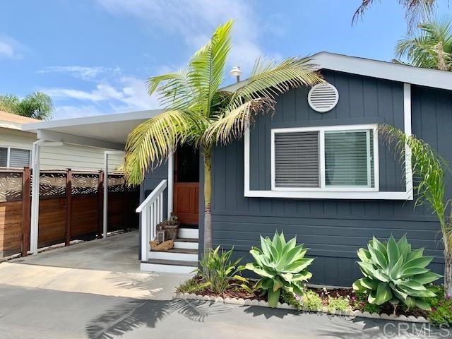 123 Jasper Street, Unit 23 Encinitas, CA 92024 - Photo 2 of 23 a front view of a house with a potted plant