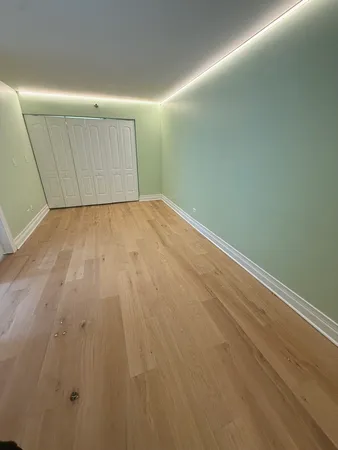 a view of a room with wooden floor
