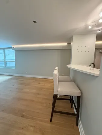 a kitchen with a table chairs refrigerator and microwave