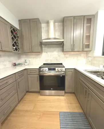 a kitchen with stainless steel appliances granite countertop a stove a sink and a refrigerator