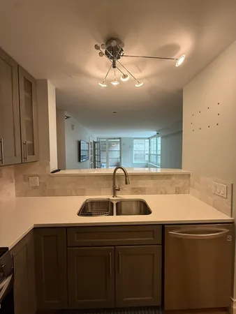 a kitchen with a sink and cabinets