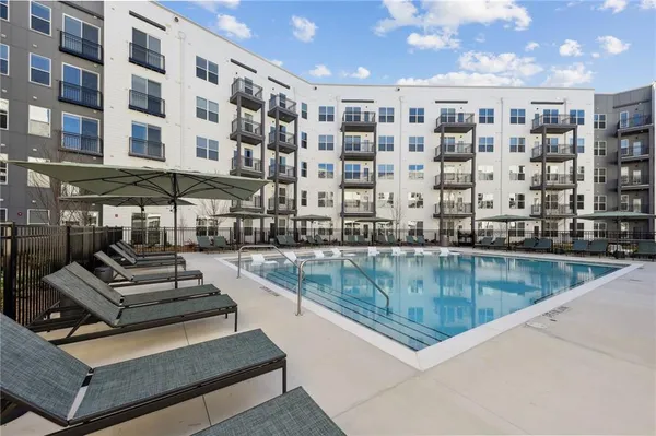 a view of a swimming pool with outdoor seating