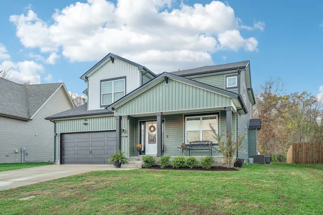 a front view of a house with a garden and yard