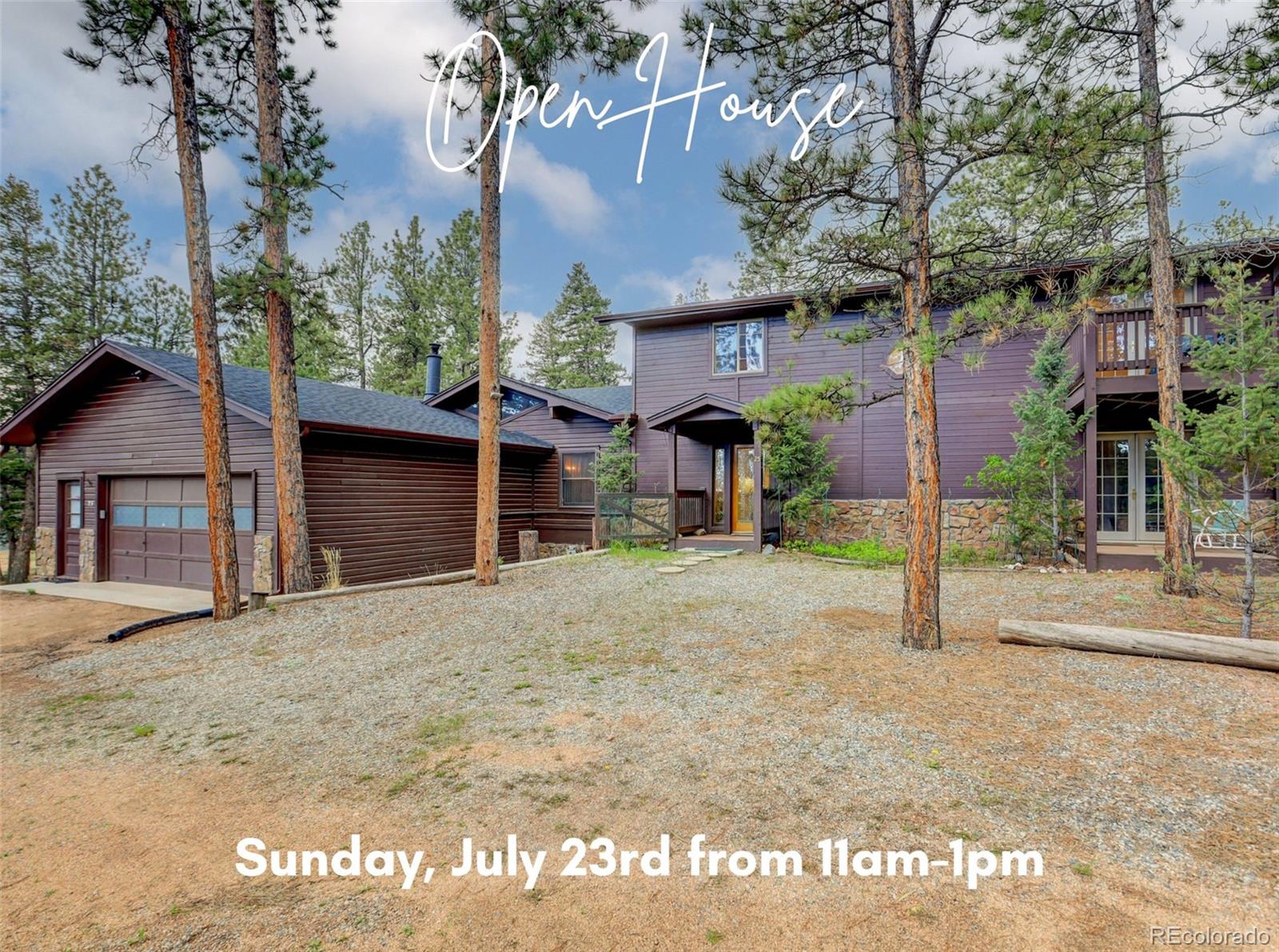 a view of a house with a yard and garage