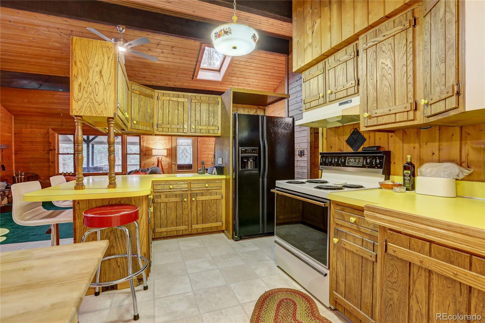 25 Granada Way Pine, CO 80470 - Photo 11 of 40 a kitchen that has a lot of cabinets in it