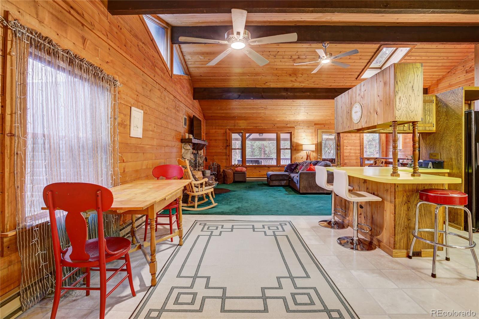 25 Granada Way Pine, CO 80470 - Photo 13 of 40 a view of a patio with table and chairs potted plants and large tree