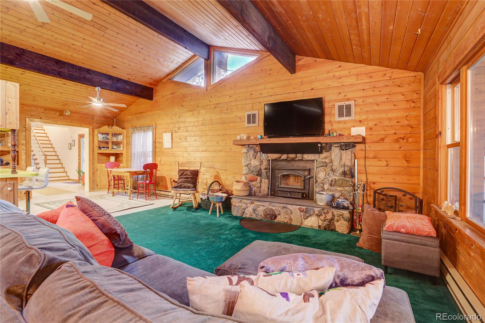 25 Granada Way Pine, CO 80470 - Photo 16 of 40 a living room with fireplace furniture and a flat screen tv