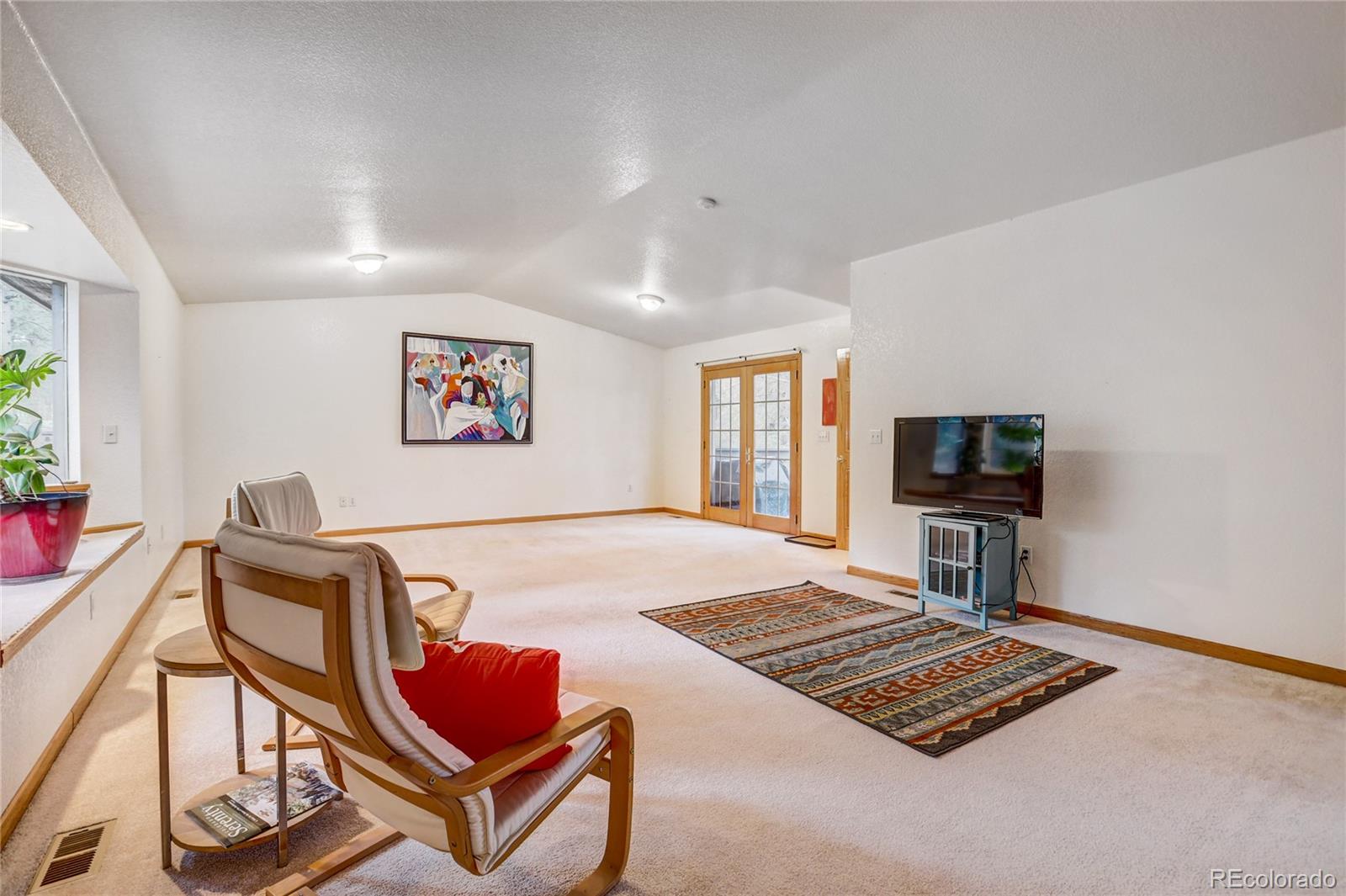 25 Granada Way Pine, CO 80470 - Photo 19 of 40 a living room with furniture rug and a window