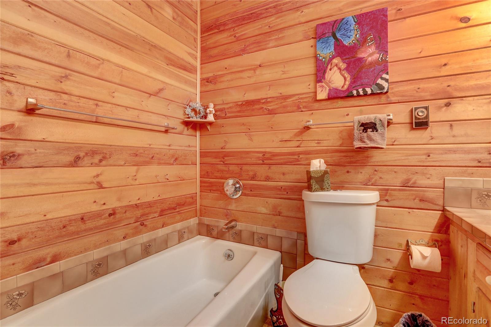 25 Granada Way Pine, CO 80470 - Photo 25 of 40 a bathroom with a toilet and sink