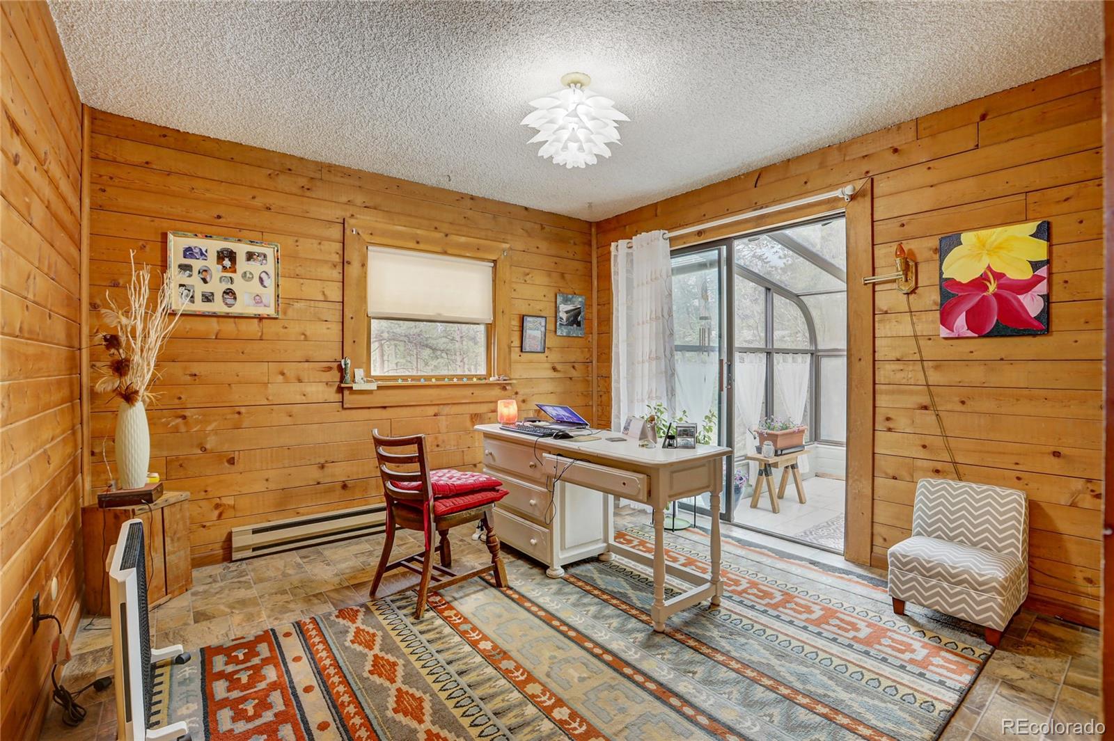 25 Granada Way Pine, CO 80470 - Photo 26 of 40 a living room with furniture and a window