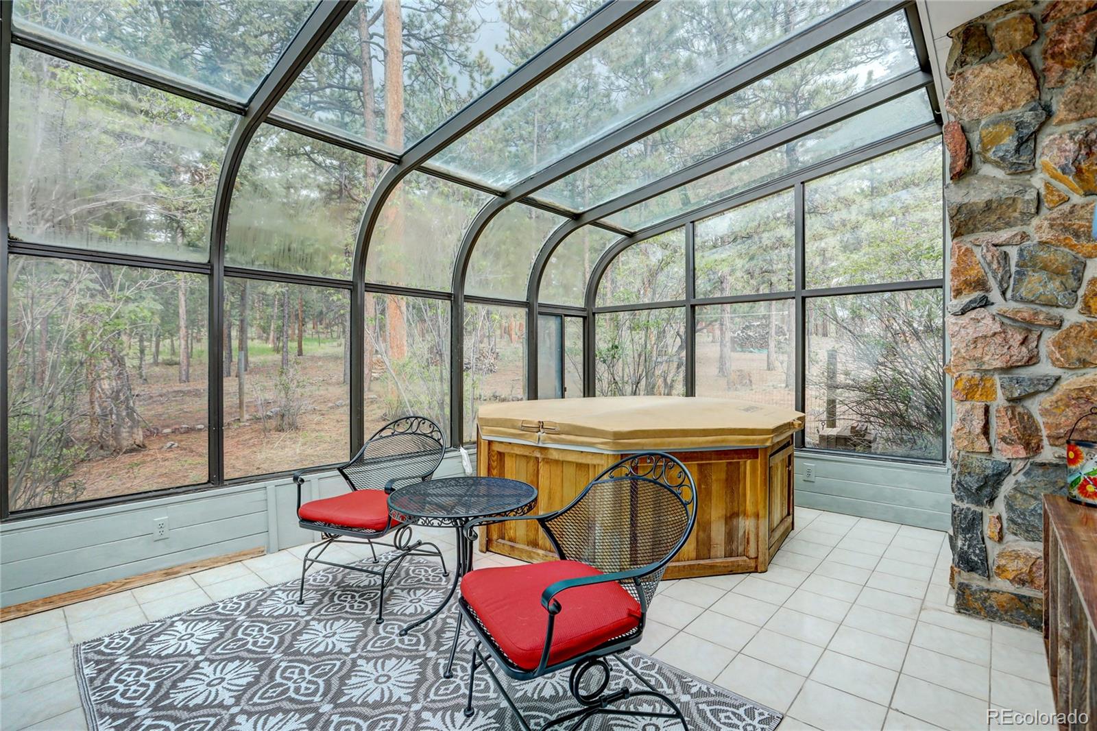 25 Granada Way Pine, CO 80470 - Photo 27 of 40 a living room with a table and chairs