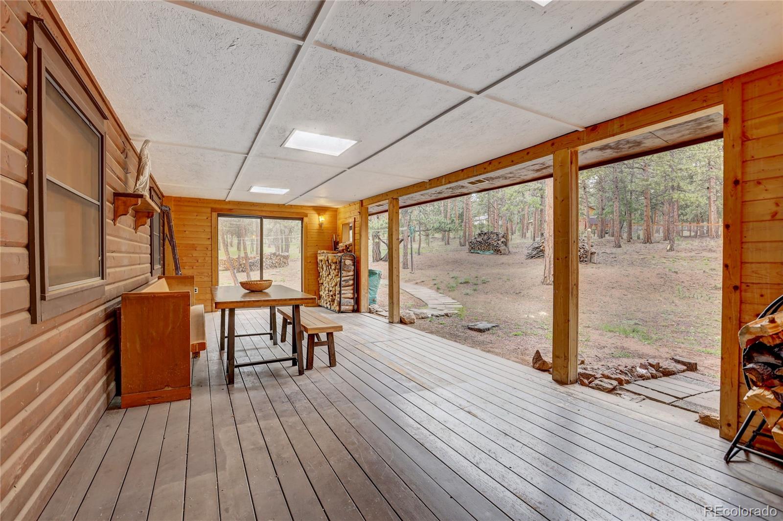 25 Granada Way Pine, CO 80470 - Photo 28 of 40 a view of a room with wooden floor and furniture