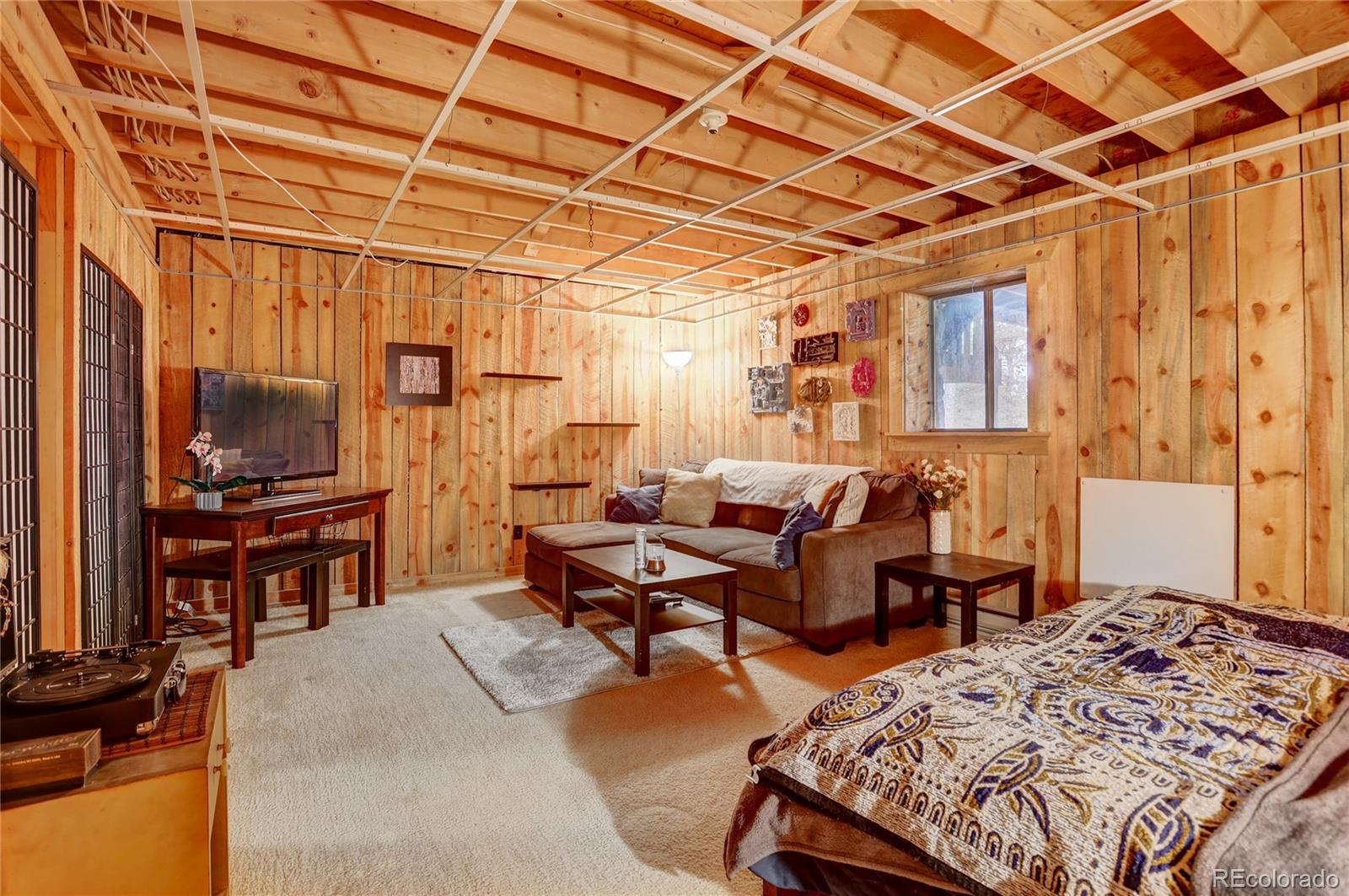 25 Granada Way Pine, CO 80470 - Photo 30 of 40 a living room with furniture and a flat screen tv
