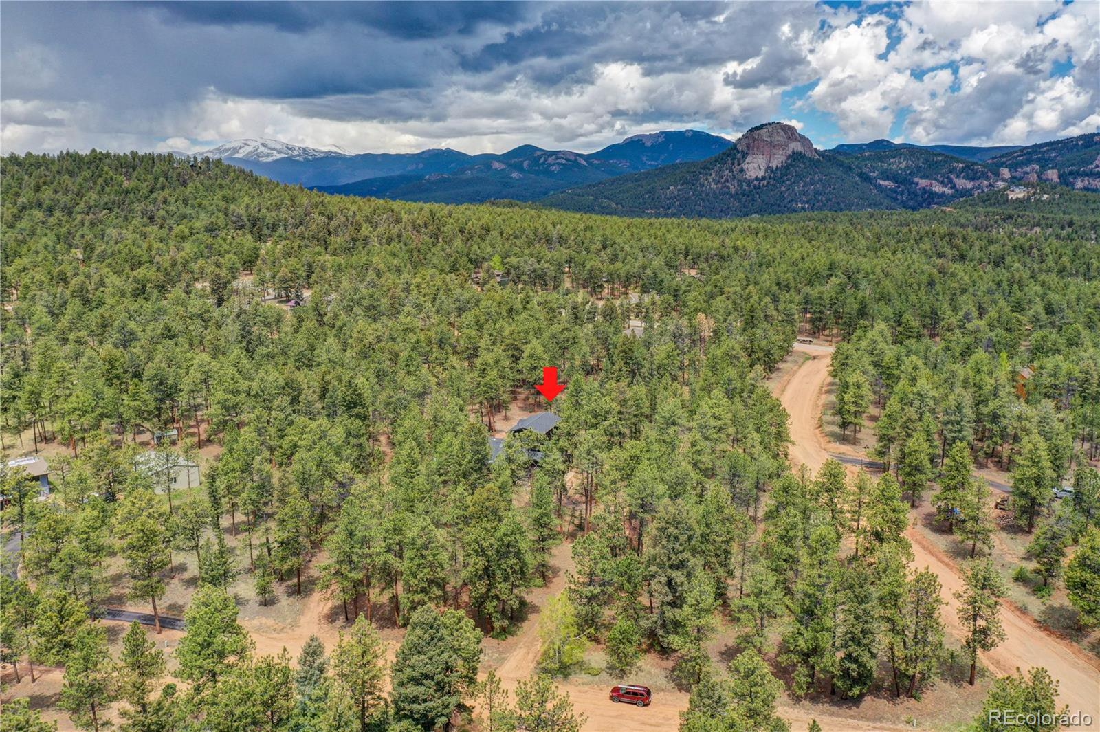 25 Granada Way Pine, CO 80470 - Photo 39 of 40 a building with trees in the background