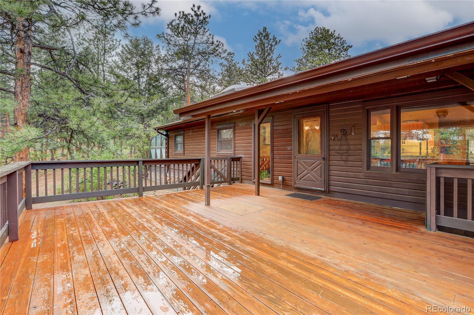 25 Granada Way Pine, CO 80470 - Photo 4 of 40 a balcony view with a seating space