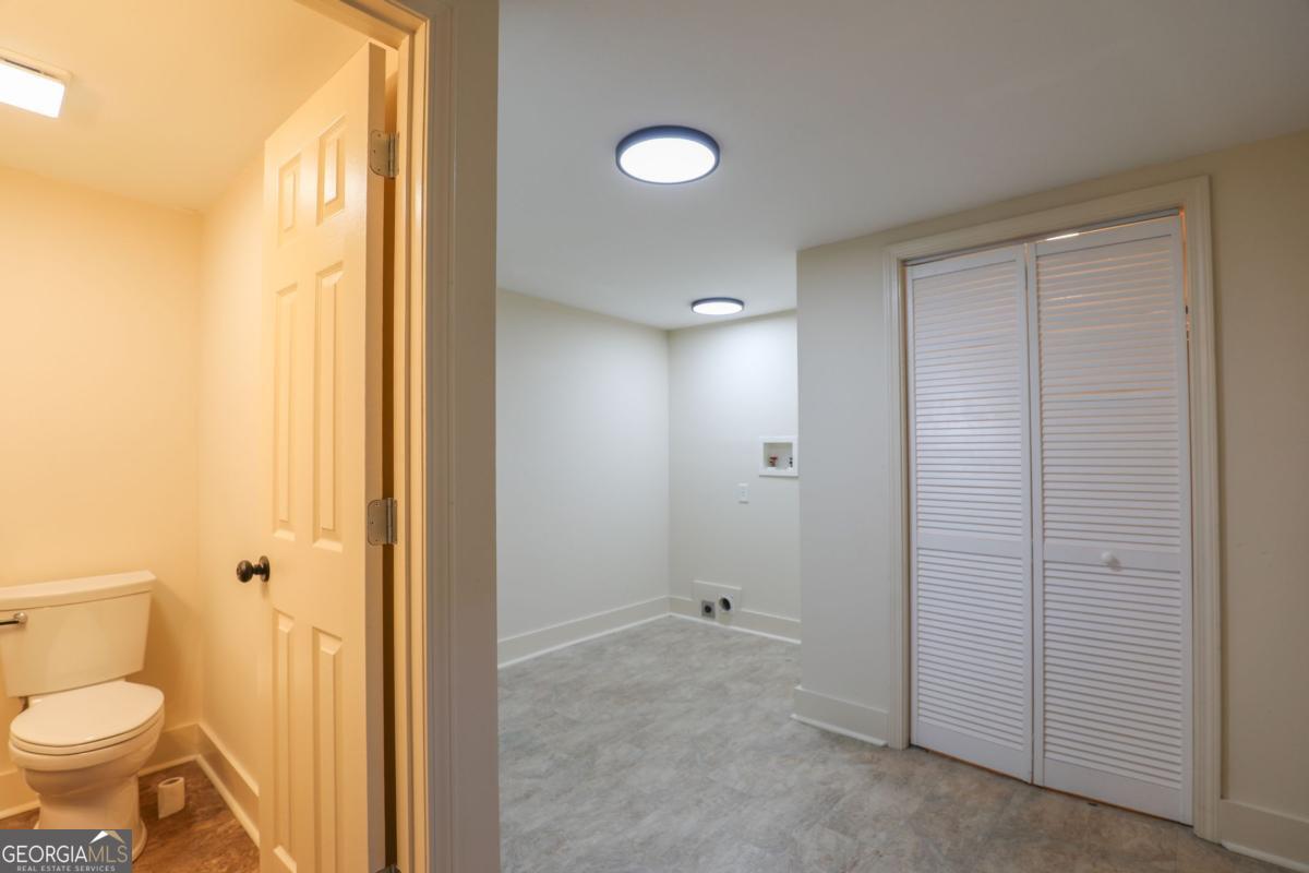 127 Fourth Street Southwest Milledgeville, GA 31061 - Photo 12 of 28 a bathroom with a granite countertop sink toilet and shower