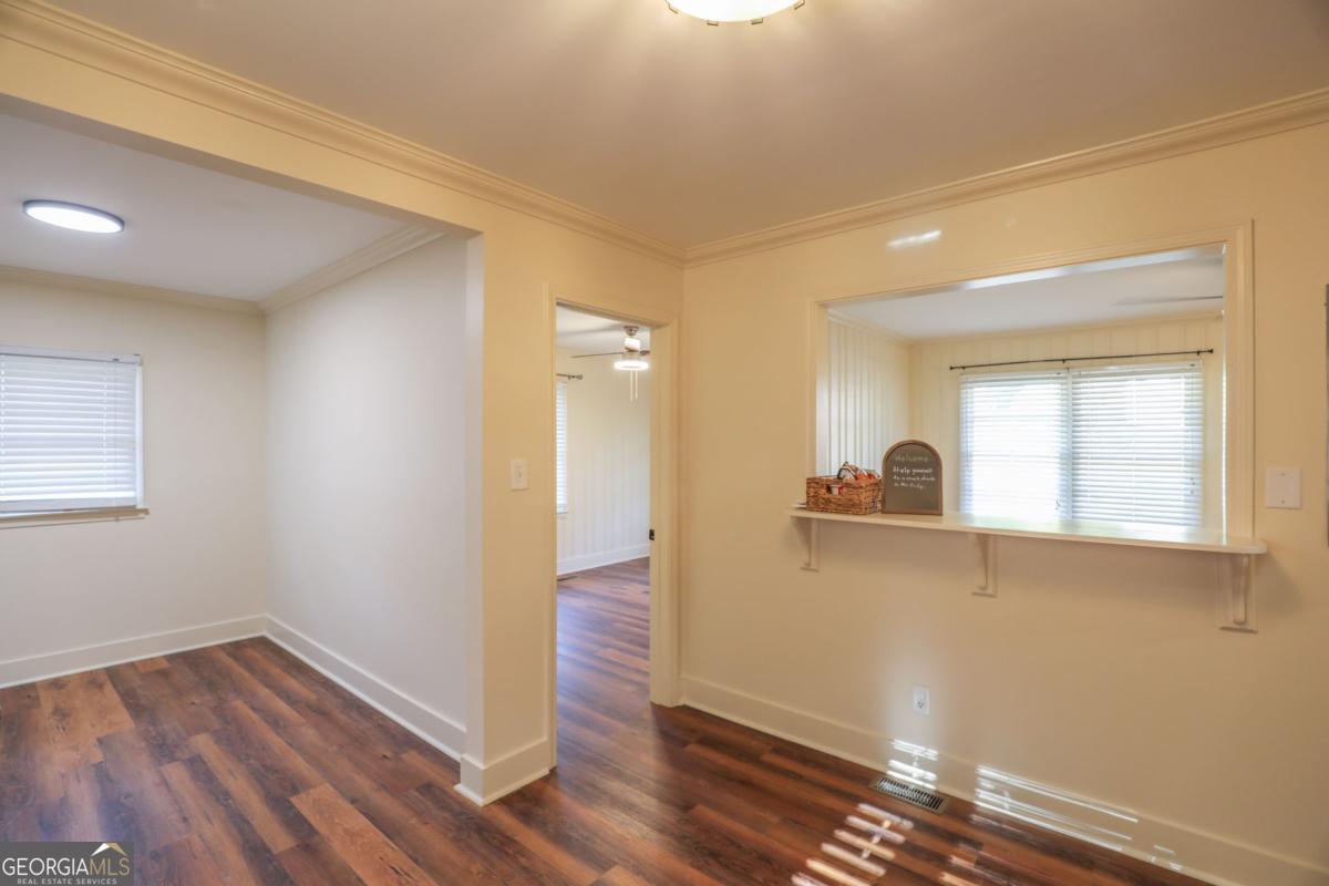 127 Fourth Street Southwest Milledgeville, GA 31061 - Photo 14 of 28 a view of a room with wooden floor and a window