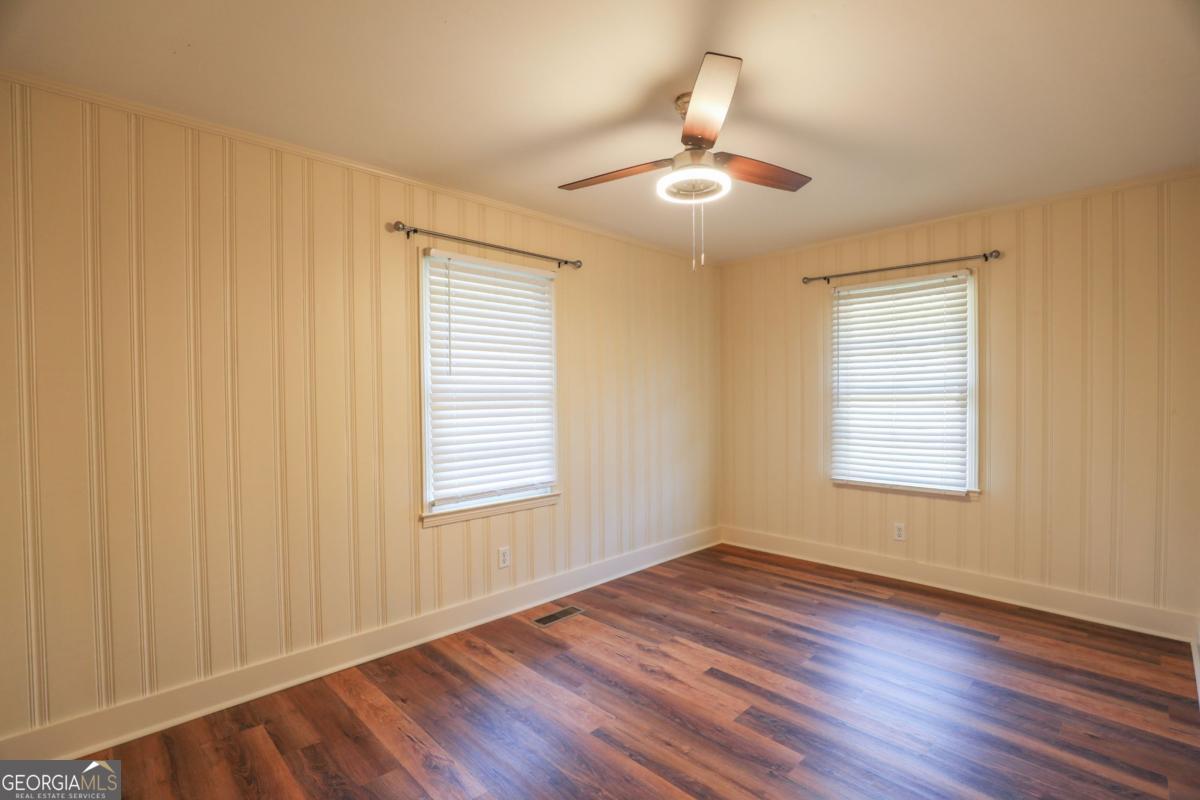 127 Fourth Street Southwest Milledgeville, GA 31061 - Photo 15 of 28 a view of an empty room with wooden floor and a window