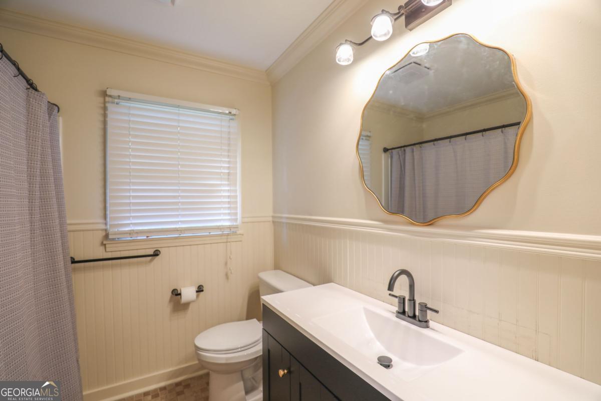 127 Fourth Street Southwest Milledgeville, GA 31061 - Photo 17 of 28 a bathroom with a sink mirror and toilet