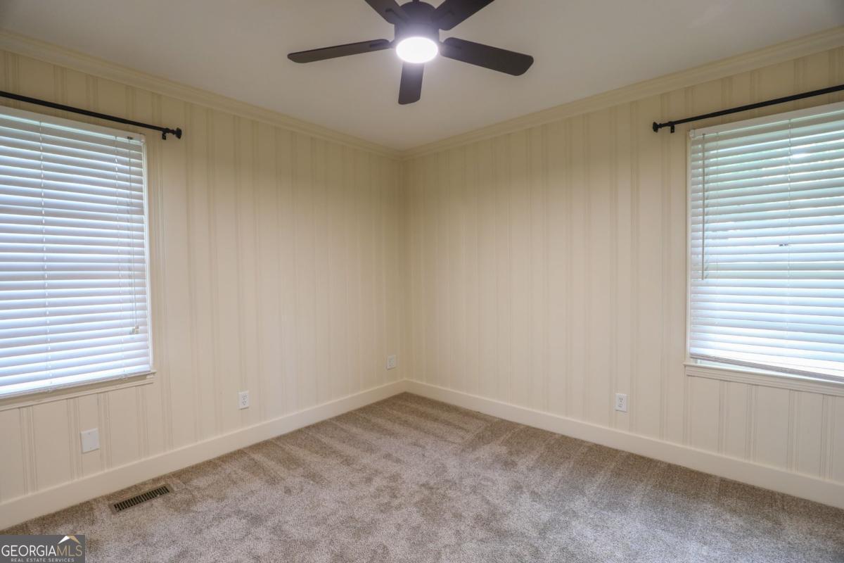 127 Fourth Street Southwest Milledgeville, GA 31061 - Photo 20 of 28 an empty room with a window and a fan