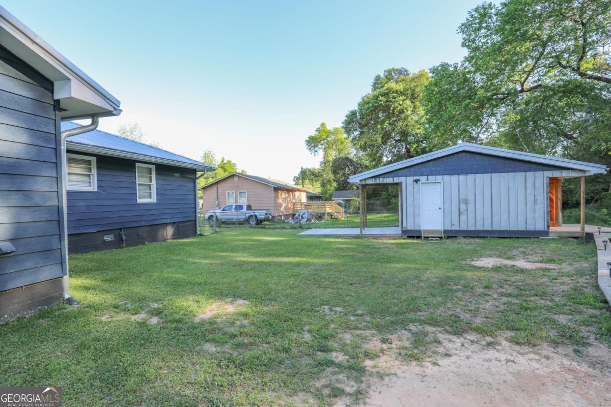 127 Fourth Street Southwest Milledgeville, GA 31061 - Photo 24 of 28 a view of a yard in front of a house with a large tree