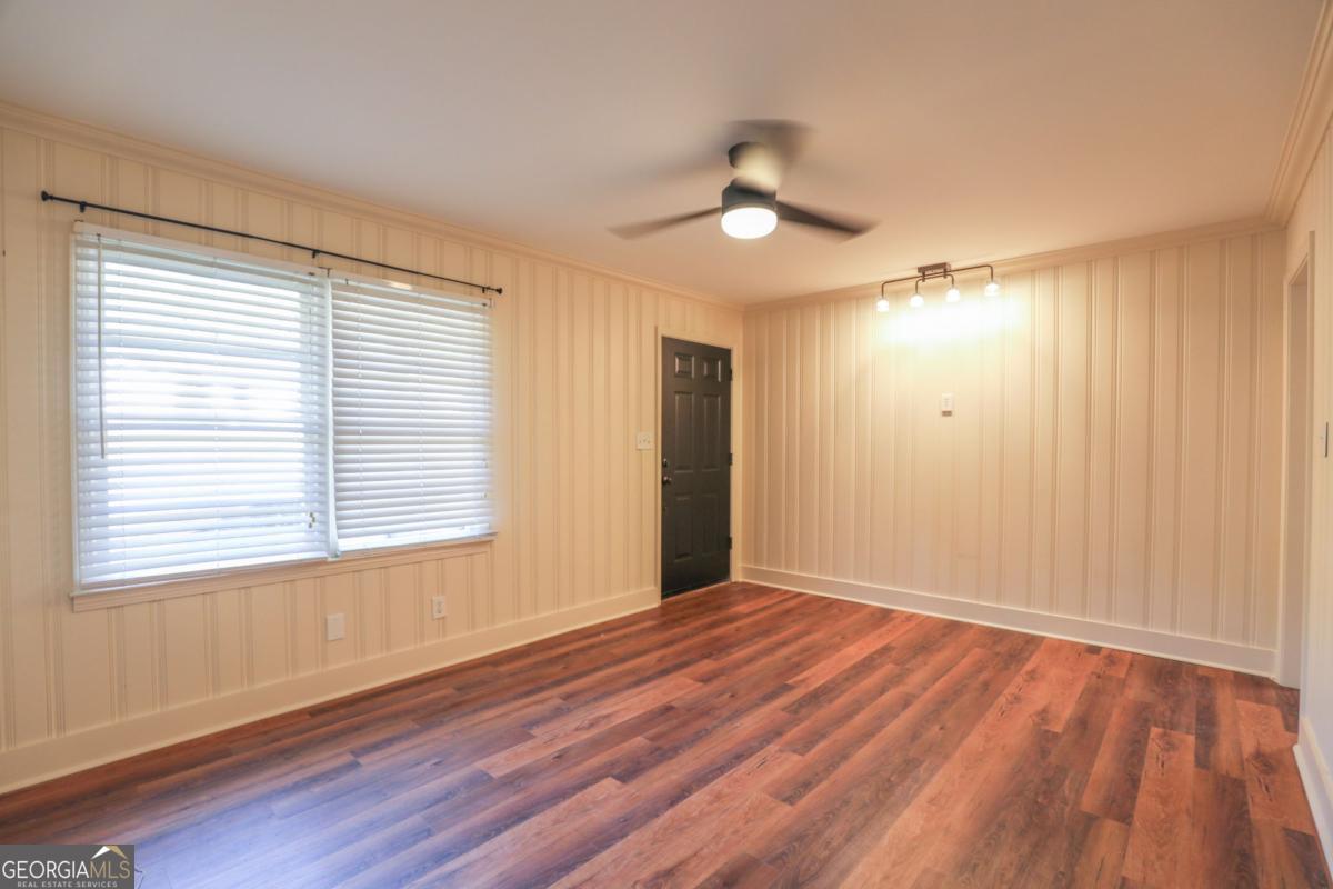127 Fourth Street Southwest Milledgeville, GA 31061 - Photo 5 of 28 a view of an empty room with wooden floor and a window