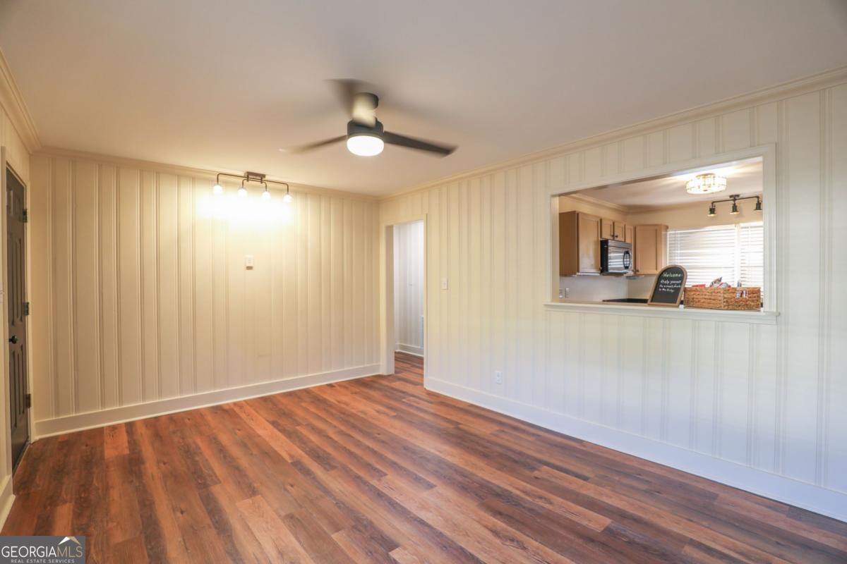 127 Fourth Street Southwest Milledgeville, GA 31061 - Photo 6 of 28 a view of empty room with wooden floor and fan