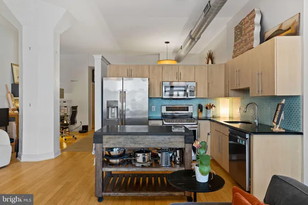 a kitchen with stainless steel appliances granite countertop a stove and cabinets