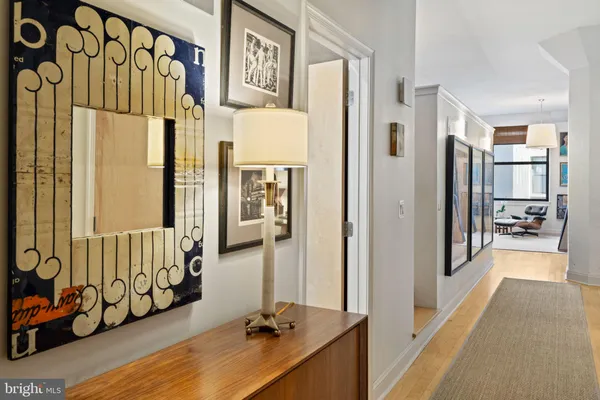 a view of a hallway with wooden floor and windows