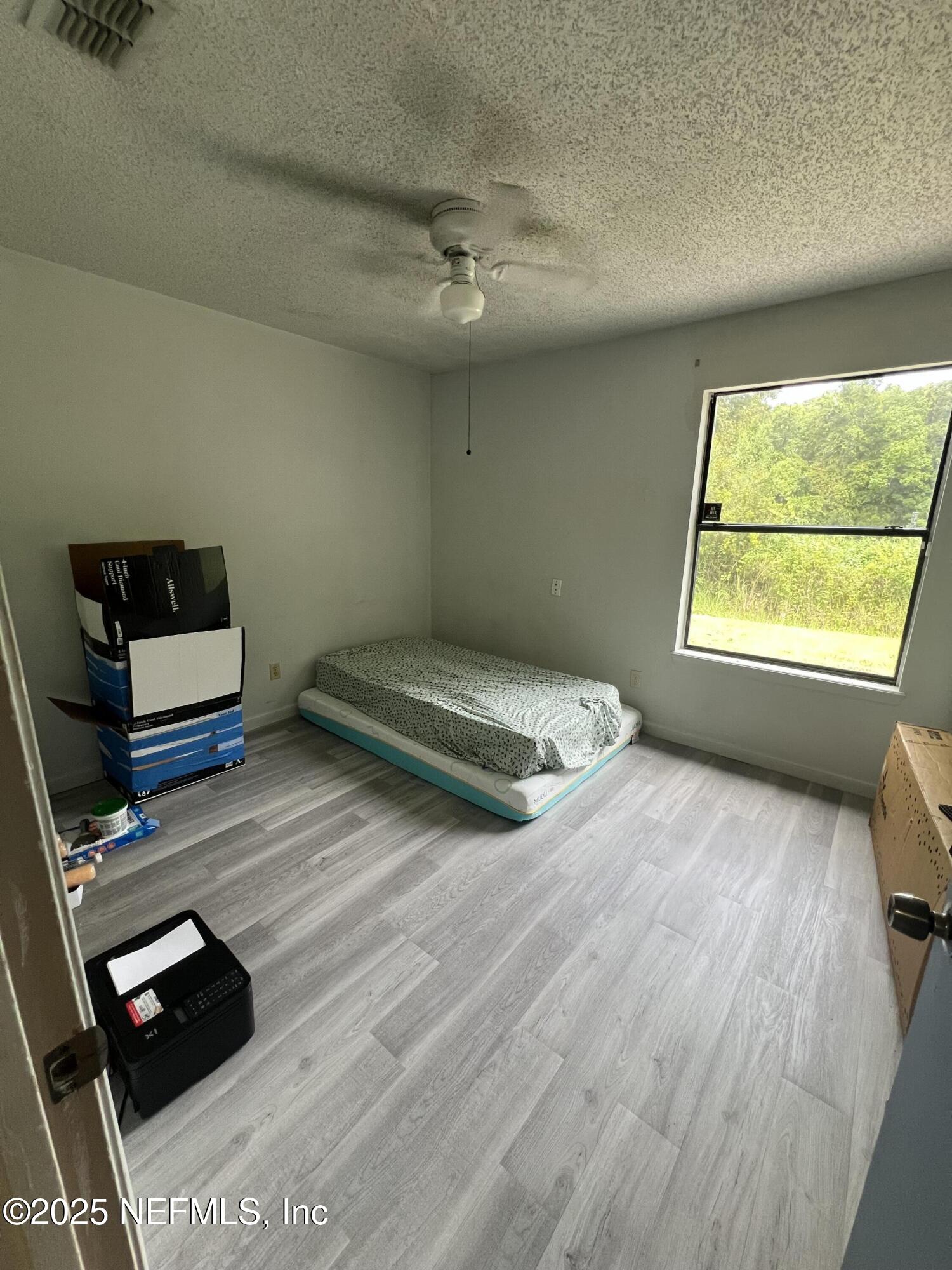 957 Aries Road West Jacksonville, FL 32216 - Photo 11 of 28 a bedroom with a bed and window