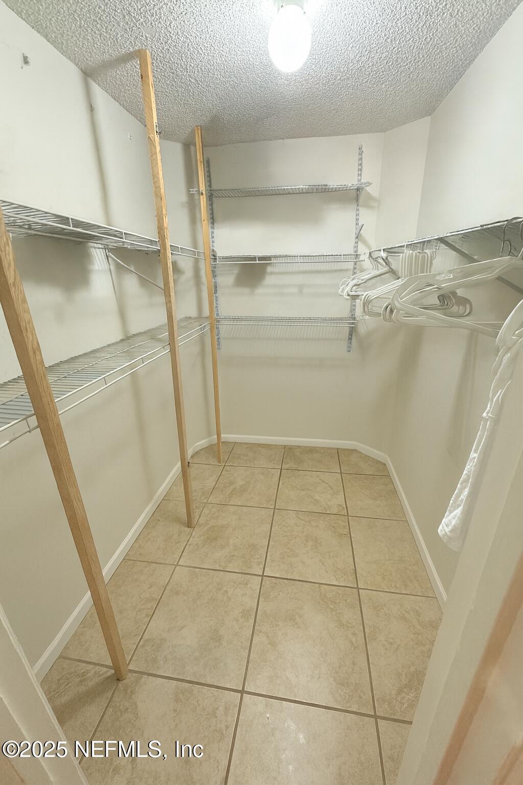 957 Aries Road West Jacksonville, FL 32216 - Photo 12 of 28 a view of walk in closet with empty racks