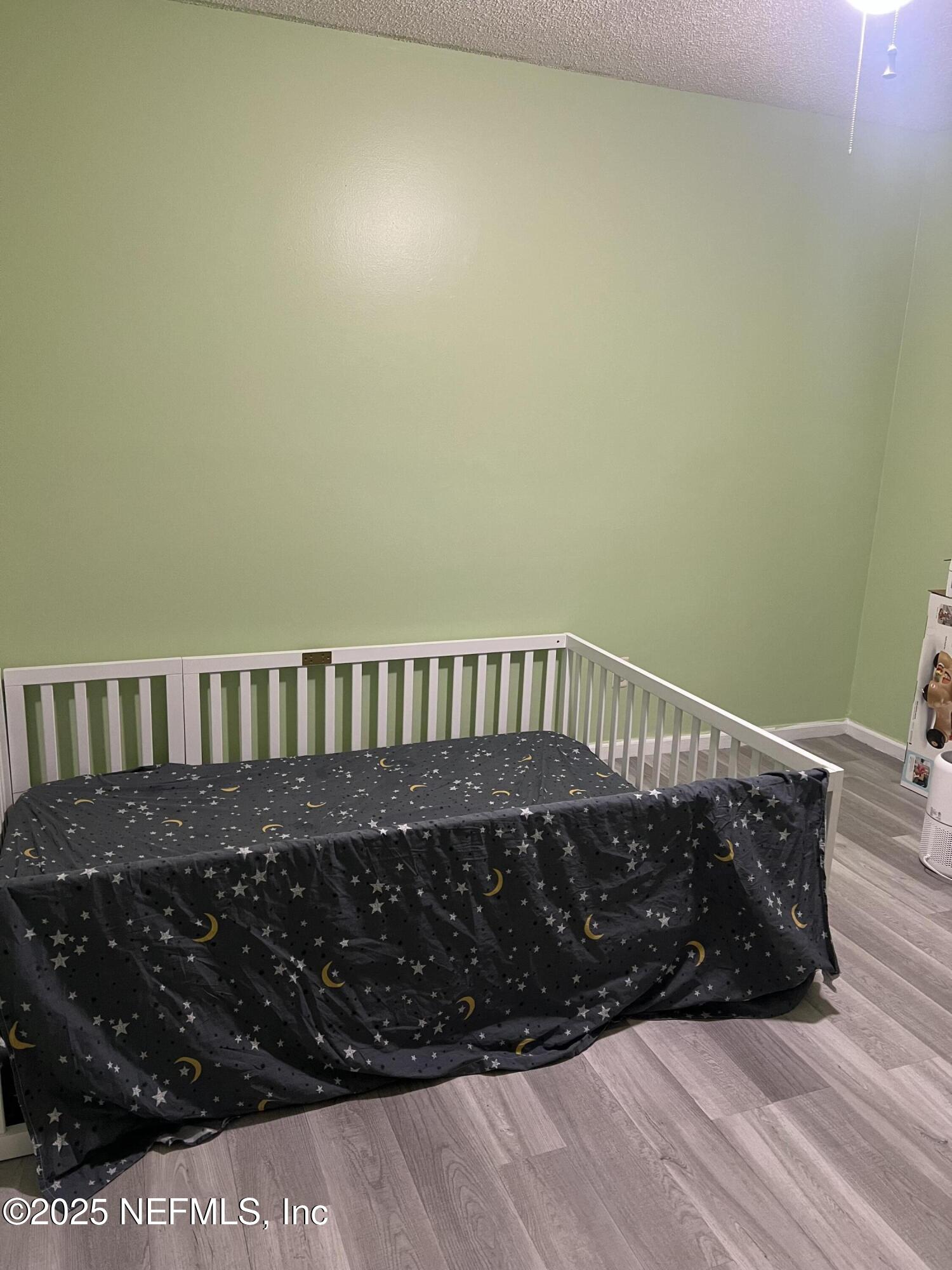 957 Aries Road West Jacksonville, FL 32216 - Photo 15 of 28 a bed sitting in a bedroom next to a wall