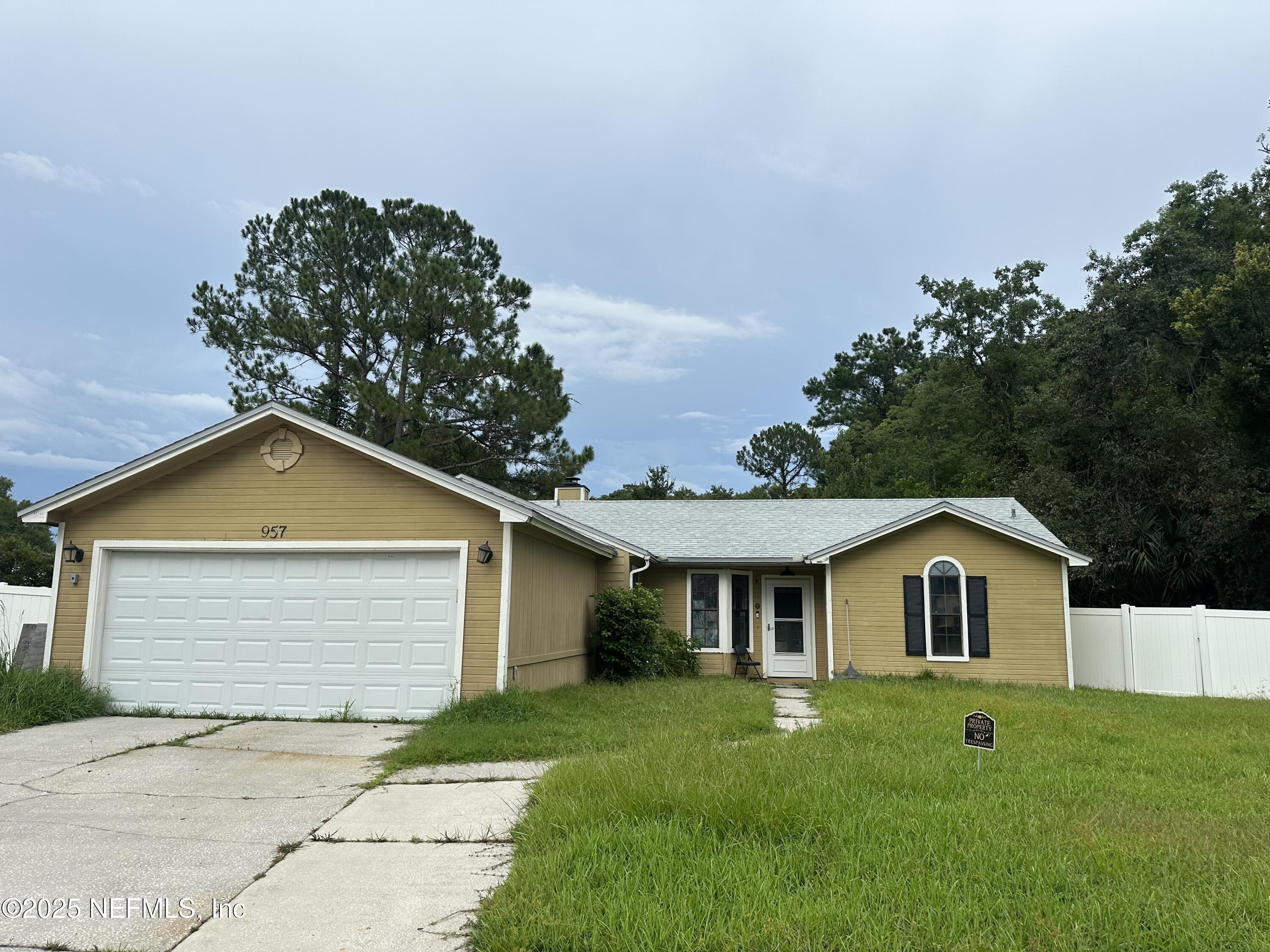 957 Aries Road West Jacksonville, FL 32216 - Photo 2 of 28 a front view of a house with a yard and garage