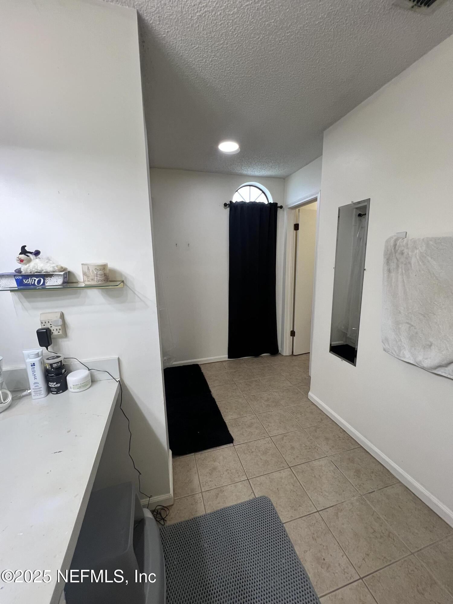 957 Aries Road West Jacksonville, FL 32216 - Photo 22 of 28 a kitchen with a sink and a refrigerator