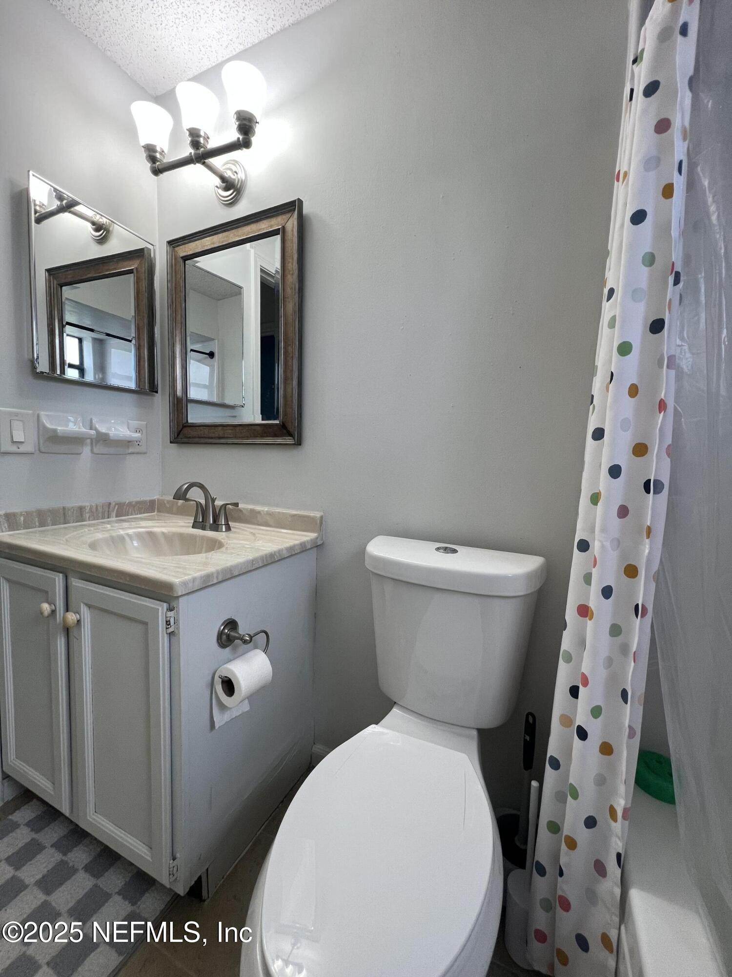 957 Aries Road West Jacksonville, FL 32216 - Photo 24 of 28 a bathroom with a sink toilet and shower