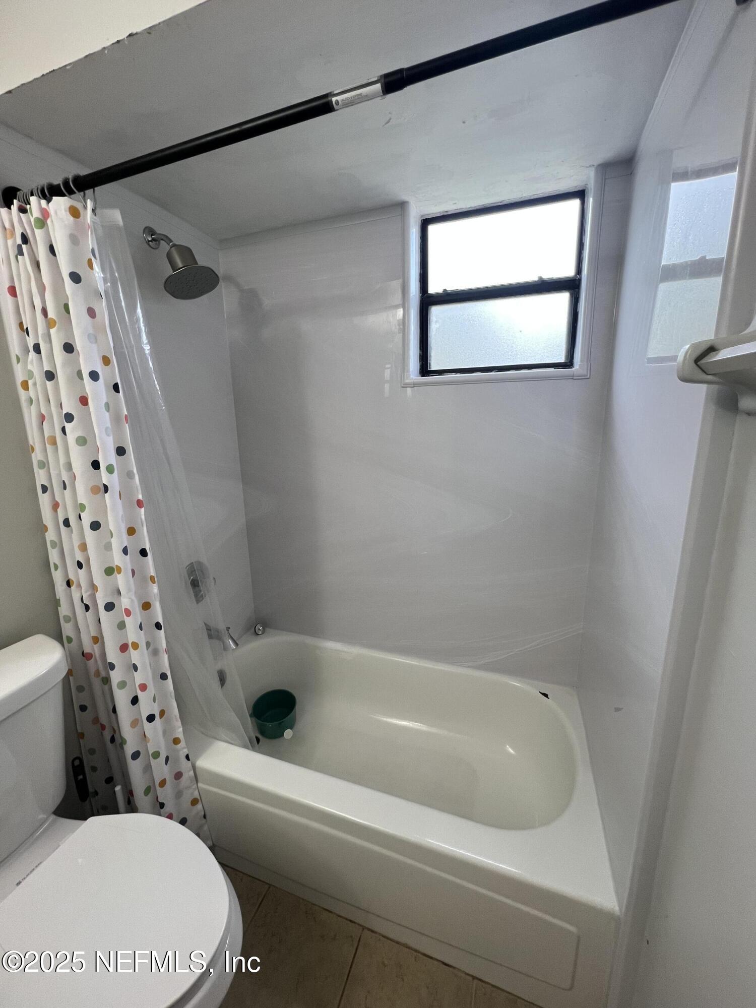 957 Aries Road West Jacksonville, FL 32216 - Photo 25 of 28 a bathroom with a toilet and a bathtub