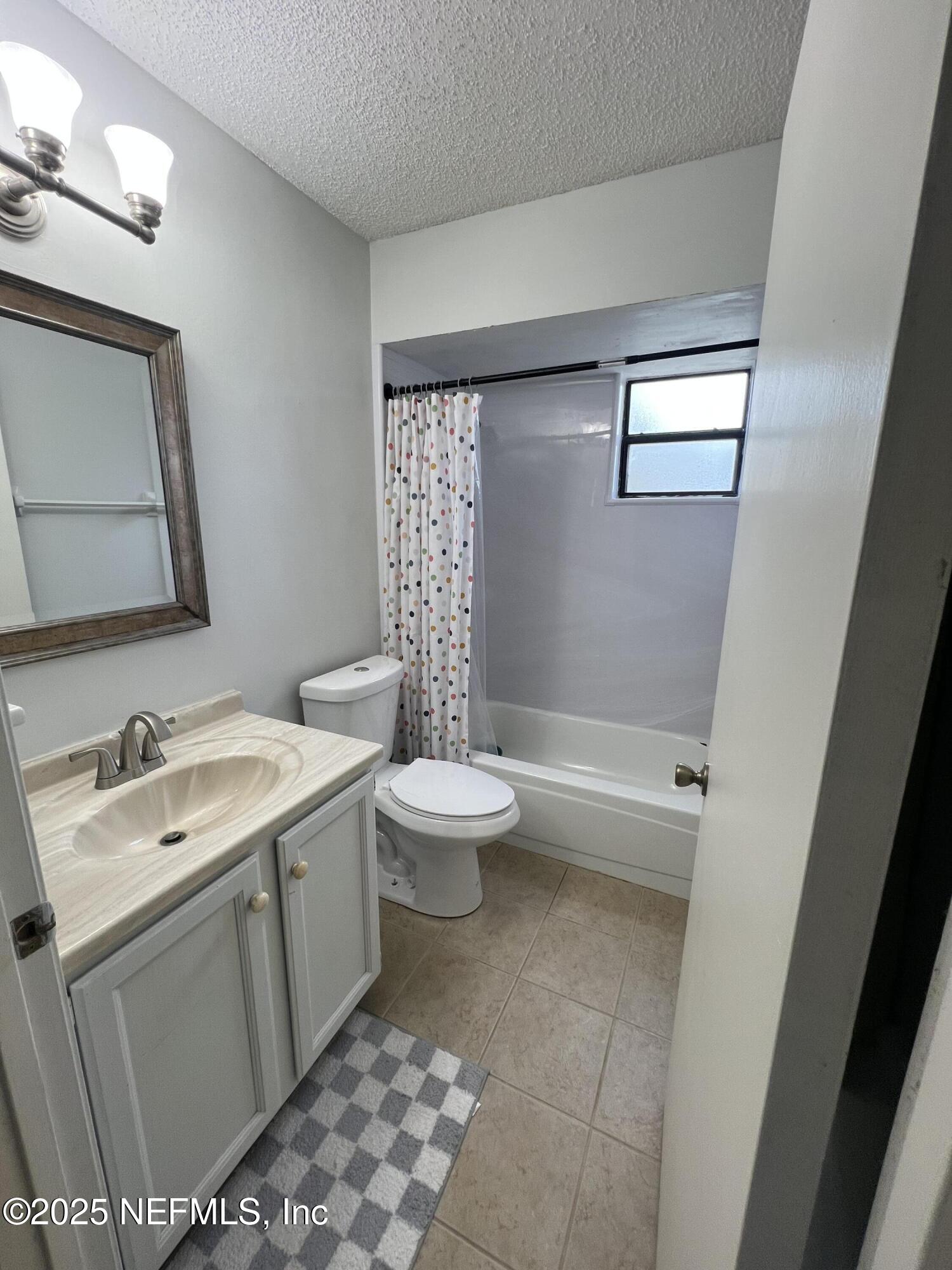 957 Aries Road West Jacksonville, FL 32216 - Photo 26 of 28 a bathroom with a sink toilet and shower