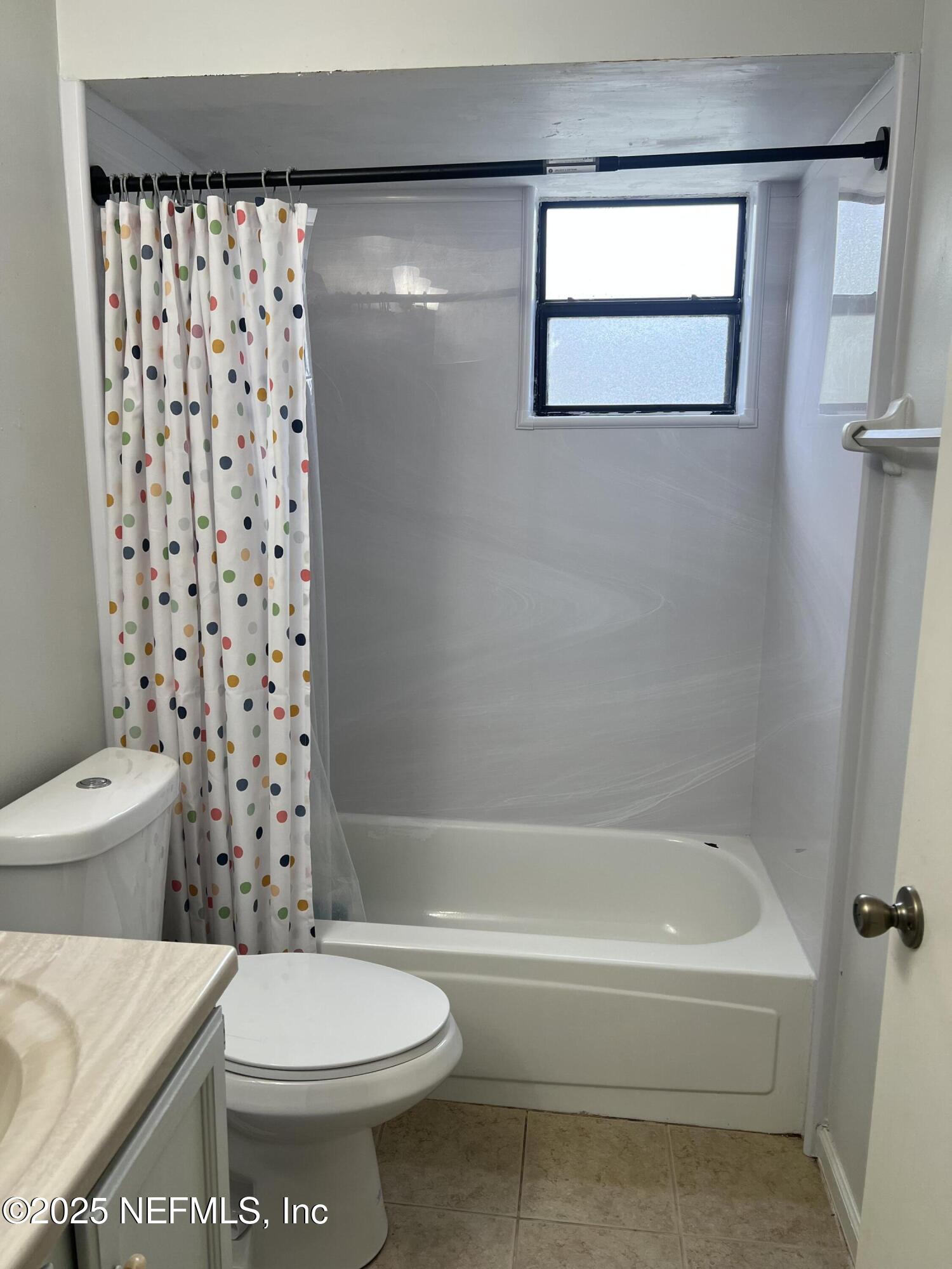957 Aries Road West Jacksonville, FL 32216 - Photo 28 of 28 a bathroom with a toilet and a bathtub
