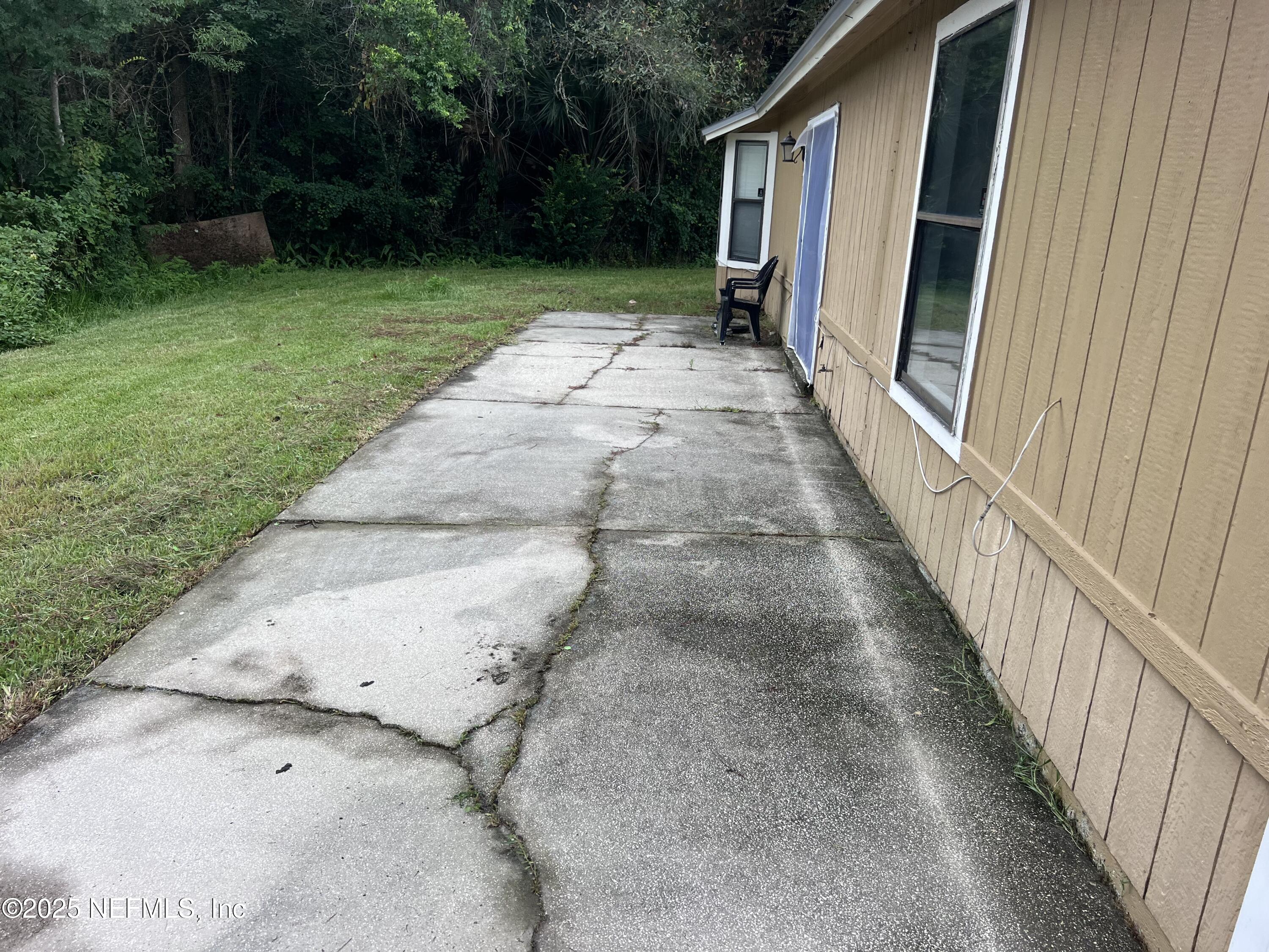 957 Aries Road West Jacksonville, FL 32216 - Photo 9 of 28 a view of a pathway of a house with backyard and garden