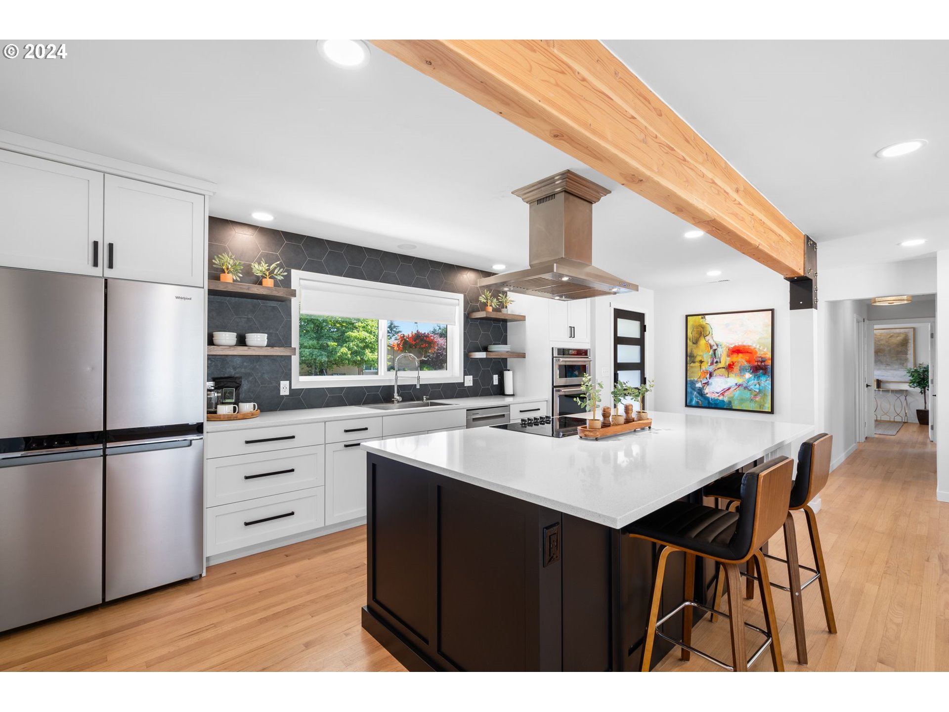 1617 Northeast Ione Loop Camas, WA 98607 - Photo 4 of 15 a kitchen with stainless steel appliances granite countertop a refrigerator a sink dishwasher a stove with white cabinets and wooden floor