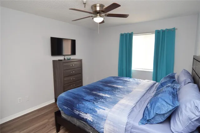 a kitchen with granite countertop a stove a sink and a refrigerator