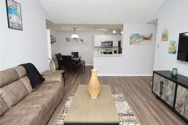 a kitchen with stainless steel appliances a stove microwave and refrigerator